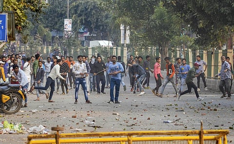 Protestors hurl stones after clashes broke out between pro and anti-CAA groups at Maujpur area, in East Delhi, Sunday, Feb. 23, 2020. (Photo | PTI)