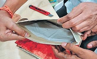 The contraband was concealed between layers of wedding cards.