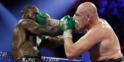 Tyson Fury, of England, lands a right to Deontay Wilder during a WBC heavyweight championship boxing match. (Photo | AP)