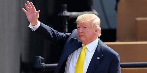 US President Donald Trump waves to the crowd as he leaves after attending the 'Namaste Trump' event at Sardar Patel Stadium in Ahmedabad. (Photo | AP)