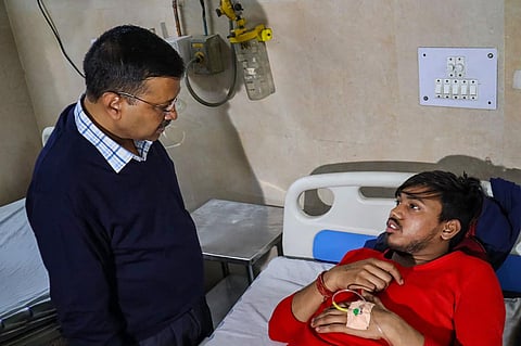 Delhi Chief Minister Arvind Kejriwal meets a victim injured in clashes over the new citizenship law at a hospital in New Delhi Tuesday Feb. 25 2020. (Photo | Twitter)