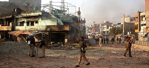 Security personnel stand guard during clashes between those supporting and against the Citizenship Amendment Act in north east Delhi Tuesday Feb. 25 2020. (Photo | Shekhar Yadav/EPS)