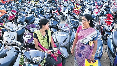 File picture of women waiting to receive two wheelers as announced by the AIADMK Government under the Amma Scooter Scheme