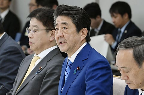 Japan's Prime Minister Shinzo Abe, center, speaks during a meeting of a task force on the new coronavirus at his official residence in Tokyo Thursday, Feb. 27, 2020. Abe was asking all elementary, middle and high schools to remain shut until spring holida
