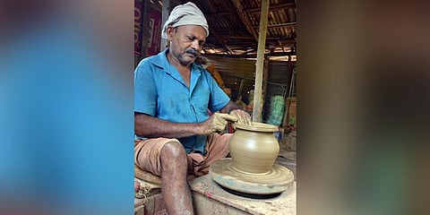 Vijayakumar, a potter in Pamamcode, shaping a pot at his workshop. (Photo | Vincent Pulickal, EPS)