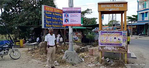 A traffic cop standing in front of a good samaritan poster (Photo | Express)