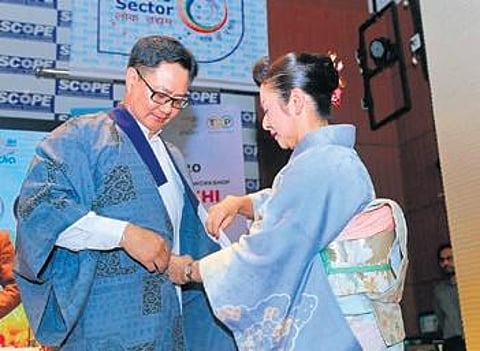 Izumi Egami helps Kiren Rijiju put on a kimono on Thursday | Express