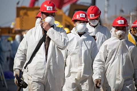 Workers walk at Leishenshan Hospital, the newly-built makeshift hospital for novel coronavirus patients, in Wuhan. (File Photo| AFP)