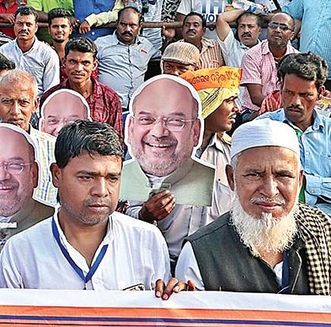 Supporters of BJP carrying masks of Home Minister Amit Shah at Janata Maidan