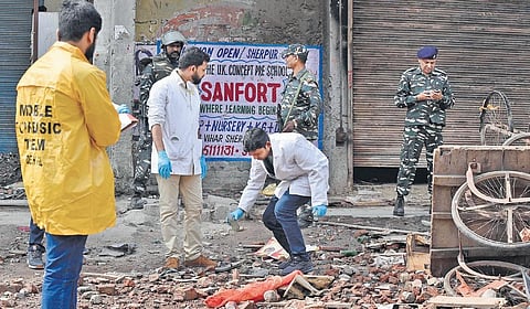 FSL team members collect evidence on a street in northeast Delhi’s Karawal Nagar. (Photo | Shekhar Yadav, EPS)