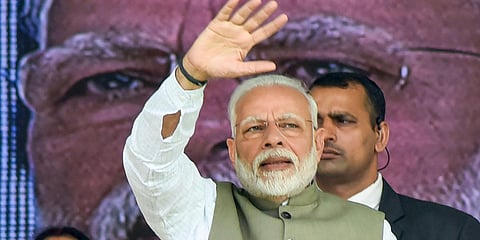 PM Narendra Modi waves at a gathering in Prayagraj. (Photo| PTI)