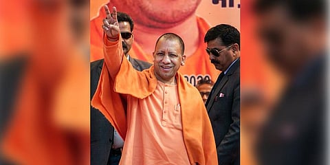 Uttar Pradesh Chief Minister Yogi Adityanath displays victory sign during an election campaign rally for the upcoming Delhi Assembly polls at Uttam Nagar in New Delhi Monday. (Photo | PTI)