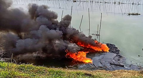 Plumes of smoke rise over a small stream of the Burhi Dihing River after a crude oil pipeline exploded in the area at Naharkatia town of Dibrugarh district Monday Feb. 3 2020. (Photo | PTI)