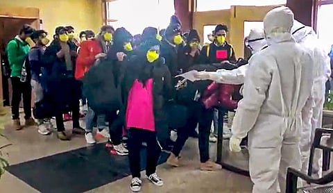 Indian nationals after they were brought by an Air India aircraft from China's coronavirus-hit city of Wuhan stand in a queue at a quarantine facility set up by ITBP at Chhawla area in New Delhi Sunday Feb. 2 2020. (Photo | Youtube Screengrab)