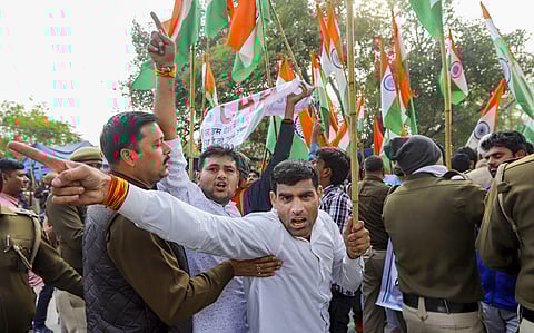 Protestors raise slogans during a pro-CAA demonstration outside Jamia University in New Delhi Tuesday Feb. 4 2020. (Photo | PTI)
