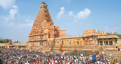 Scores of people gathered at Brihadeeswarar temple to witness the consecration; (inset) holy water being poured over Kalasam | mk ashok kumar