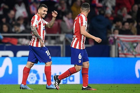 Atletico Madrid's Argentine forward Angel Correa (L) celebrates after scoring the opening goal during the Spanish league football match between Club Atletico de Madrid and Granada FC at the Wanda Metropolitano stadium in Madrid on February 8, 2020. (Photo