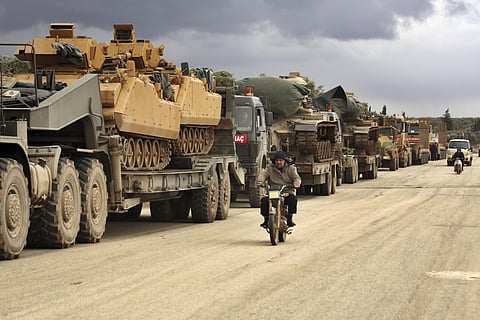 Turkish military convoy drives through the village of Binnish in Idlib province of Syria. (Photo | AP)