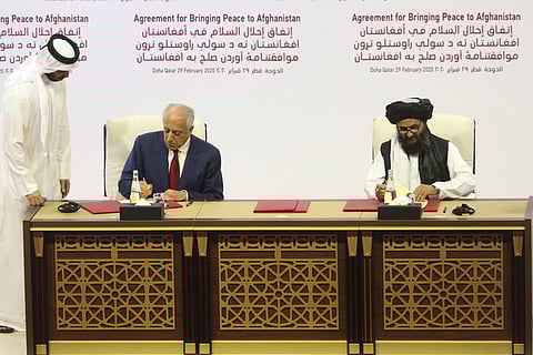 U.S. peace envoy Zalmay Khalilzad, left, and Mullah Abdul Ghani Baradar, the Taliban group's top political leader sign a peace agreement between Taliban and U.S. officials in Doha, Qatar, Saturday, Feb. 29, 2020. (Photo | PTI)