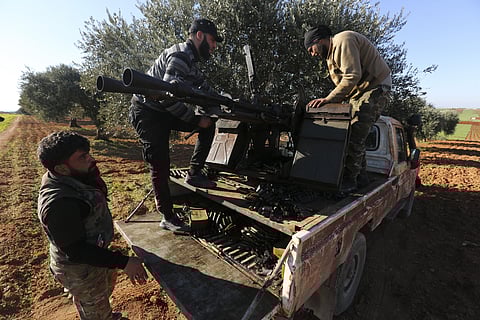 Turkish backed Syrian fighters load ammunition at a frontline near the town of Saraqib in Idlib province, Syria. (Photo | AP)