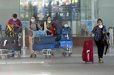 Passengers wearing masks at the Chennai airport on Monday. (Photo | Martin Louis, EPS)