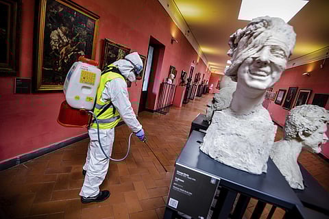 A worker sprays disinfectant as sanitization operations against Coronavirus are carried out in the museum hosted by the Maschio Angioino medieval castle, in Naples, Italy. (Photo | AP)