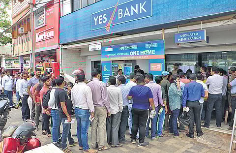 Customers queue up outside Yes Bank to withdraw cash in Bhubaneswar | Irfana