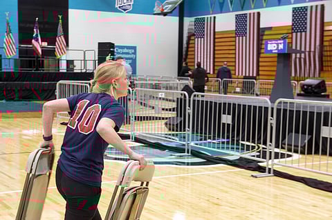 A worker carries chairs after a campaign rally for Democratic presidential candidate former Vice President Joe Biden was cancelled at Cuyahoga Community College Tuesday, March 10, 2020, in Cleveland, due to health concerns with the coronavirus. (Photo | A