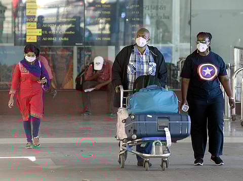 Passengers wear masks as a precautionary measure against the coronavirus at Chennai airport on Monday. (Photo | Martin Louis/EPS)