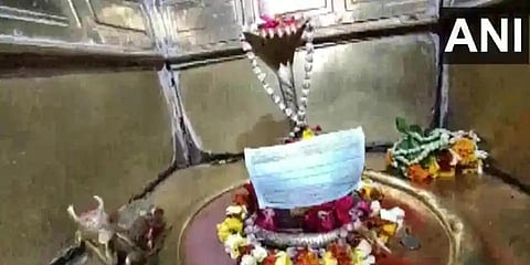 A Varanasi temple has put face masks on deities and appealed the devotees to not touch the idols. (Photo | ANI)