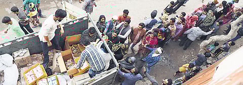 Self-help groups and NGOs distributing food packets to riot-hit people at Indira Vihar on Sunday. |Parveen Negi