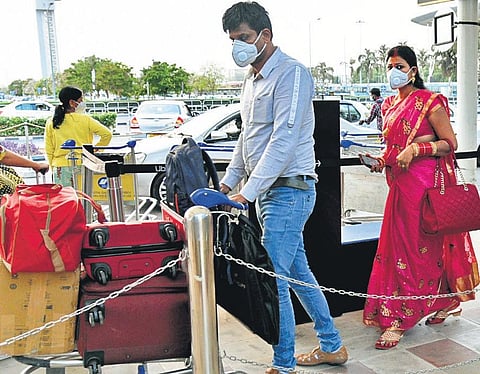 Air passengers take precautions at the KIA in Bengaluru on Wednesday | Express