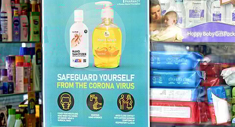 A poster urging the public to use hand sanitisers at a pharmacy in Hyderabad. (Photo | S Senbagapandiyan, EPS)