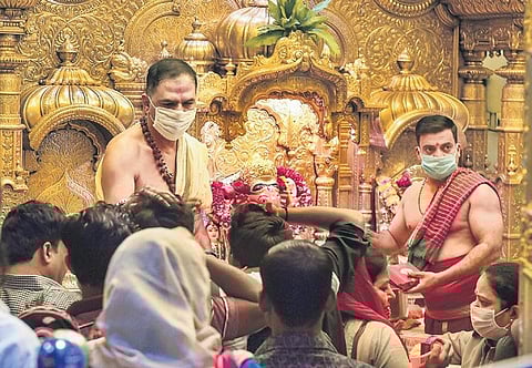 Priests wearing protective mask at Siddhivinayak Temple in Mumbai on Friday | pti