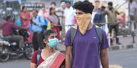 People cover their faces in public near Thampanoor bus Terminal in Thiruvananthapuram. (Photo| BP Deepu, EPS)