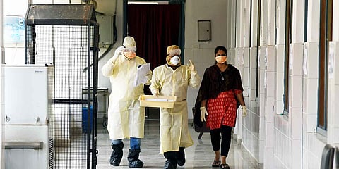 Doctors in full safety dress arrive to collect the sample from a patient at the isolation ward at Patna Medical College and Hospital. (Photo| ANI)