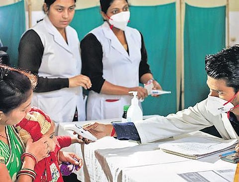 A child is examined for coronavirus in New Delhi. (Photo | PTI)