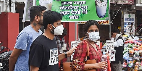 People wear protective masks in view of coronavirus pandemic at a market in Lucknow. (Photo| PTI)