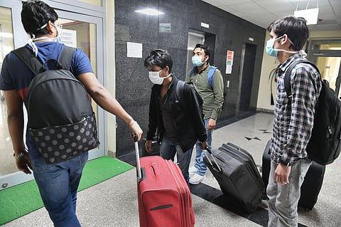 Evacuees leave after they were tested negative for the novel coronavirus COVID-19 at the ITBP facility in Chhawla Friday. (Photo | PTI)