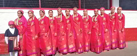 Women and a child don traditional attire at a Keri function