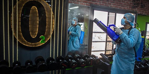 A Palestinian health worker sprays disinfectant as a precaution against the coronavirus in a gymnasium in Gaza City. (Photo| AP)