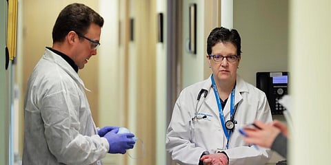 Doctors discuss the first-stage safety study clinical trial of a potential coronavirus vaccine, which began on Monday. (Photo| AP)