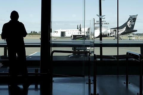 A passenger waits for his flight at Christchurch Airport in New Zealand, Monday, March 16, 2020.