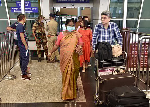 A woman seen with a mask as a preventive measure for coronavirus at Coimbatore International Airport at Sunday. (Photo | U Rakesh Kumar/EPS)
