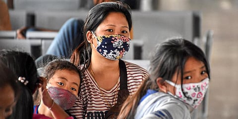Passengers wear masks as a preventive measure against coronavirus at Guwahati Railway Station on Monday. (Photo| PTI)