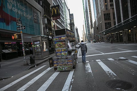 A food truck vendor pushes his cart down an empty street near Times Square in New York, on Sunday, March 15, 2020. (Photo | AP)