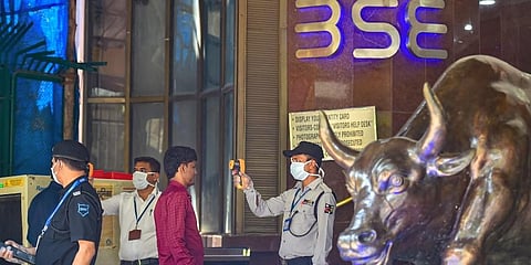 Security personnel use thermal screening devices on visitors to mitigate the coronavirus pandemic at BSE Building in Mumbai. (Photo | PTI)