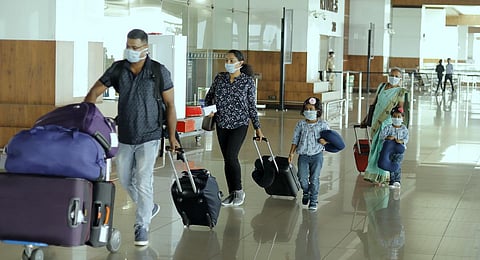 A family reaches Kochi airport wearing safety masks. (Photo | Arun Angela, EPS)