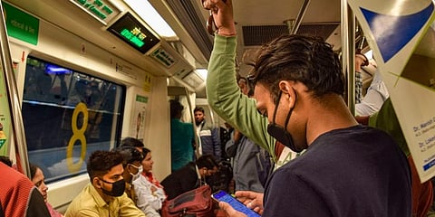 Passengers wear masks while travelling in a Delhi metro train as a prevention measure against coronavirus. (Photo | PTI)