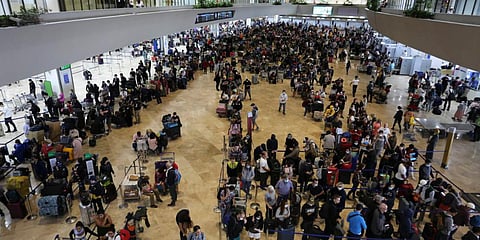 Passengers wait for their flight at the departure area of Manila's International Airport, Philippines on Tuesday. (Photo| AP)